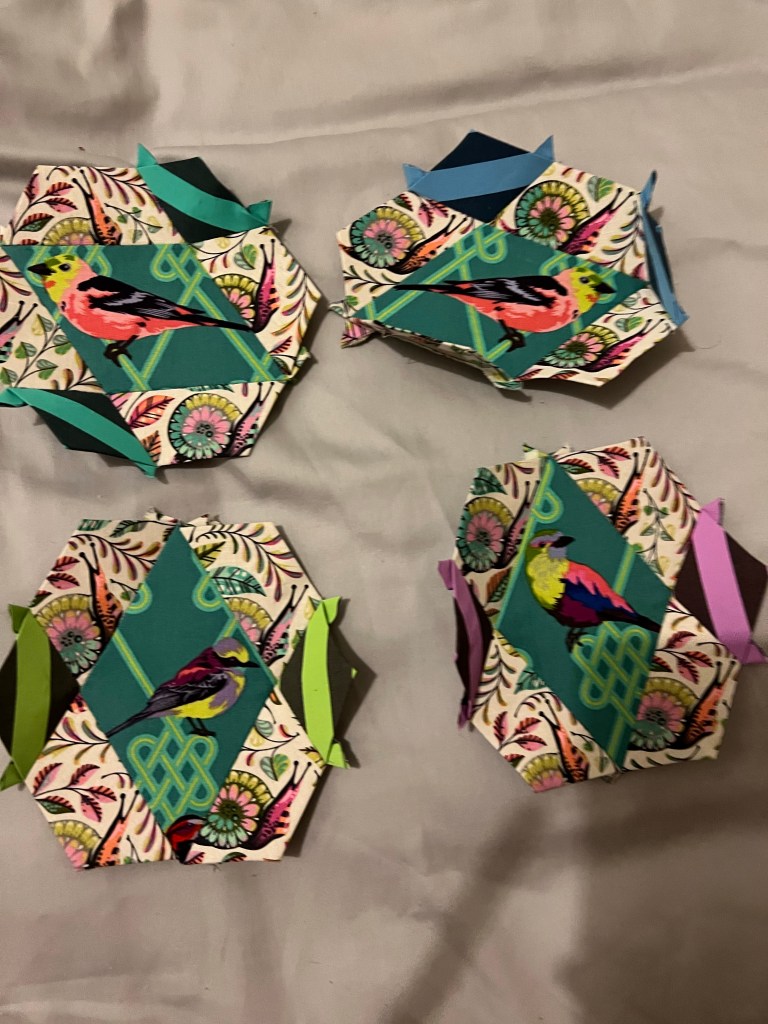 4 hexagons arranged in a square. The top right instead of sewing the small diamond in the second gap opposite the 1st I sewed it to the straight side turning it into a 3D object rather than the flat hexagon it should be.