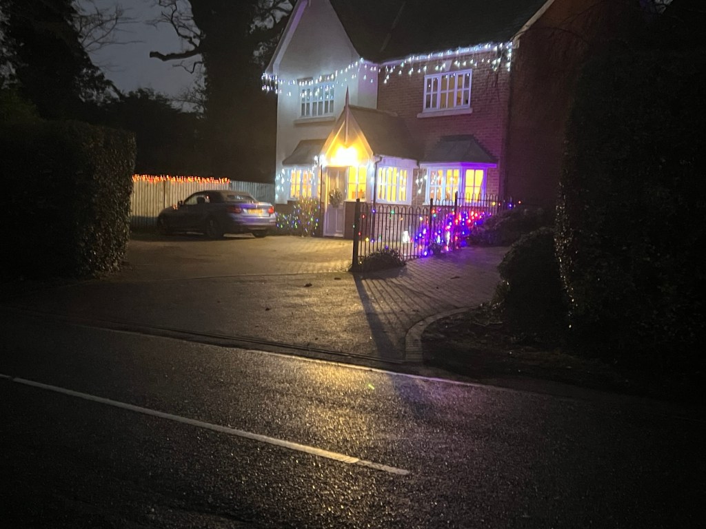 Multicoloured lights outside a house on one of the houses I past in Digswell.
