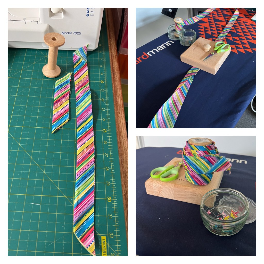 The image is a collage of three photos showing a sewing or crafting setup. 

The left photo shows a sewing machine labeled "Model 7025" on a table with a green cutting mat. On the mat, there is a wooden spool and two pieces of colorful striped fabric cut into long, narrow strips. The fabric has diagonal stripes in various colors, including blue, pink, yellow, and green. It is what’s left after binding a quilt.

The top right photo shows a long strip of the same colorful fabric laid  on my ironing board. The binding is being pressed in half and wound onto a spool ready to sew round the raw edges of a quilt. There is a small wooden block (called a clapper that helps set the crease) with a pair of green-handled scissors and a small glass jar for fabric and thread clippings next to it.

The bottom right photo shows a close-up of the same setup with the fabric rolled up into a coil. The green-handled scissors and the glass jar which contains clippings, are placed on the wooden block.