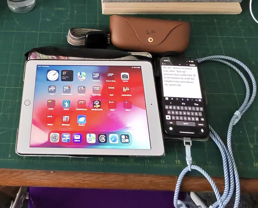 My iPad showing the apps on my screen is left of my iPhone which shows this blogpost being typed. Above them are my Apple Watch and my Meta smart glasses power case.
Photo was taken using my smart glasses.